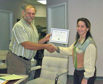 Land Trust Chair Linda Greck presents Founding Chair Nick Maniatis with a certificate honoring his service.