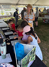 Booth visitor at Davie Land Trust Orange Blossom festival-16
																															 
																															 