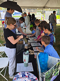 Booth visitor at Davie Land Trust Orange Blossom festival-5