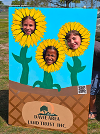 Booth visitor at Davie Land Trust Orange Blossom festival-7