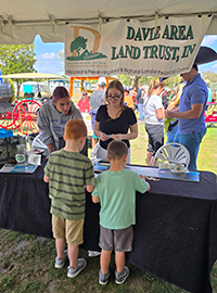 Booth visitor at Davie Land Trust Orange Blossom festival-8