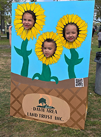 Booth visitor at Davie Land Trust Orange Blossom festival-9